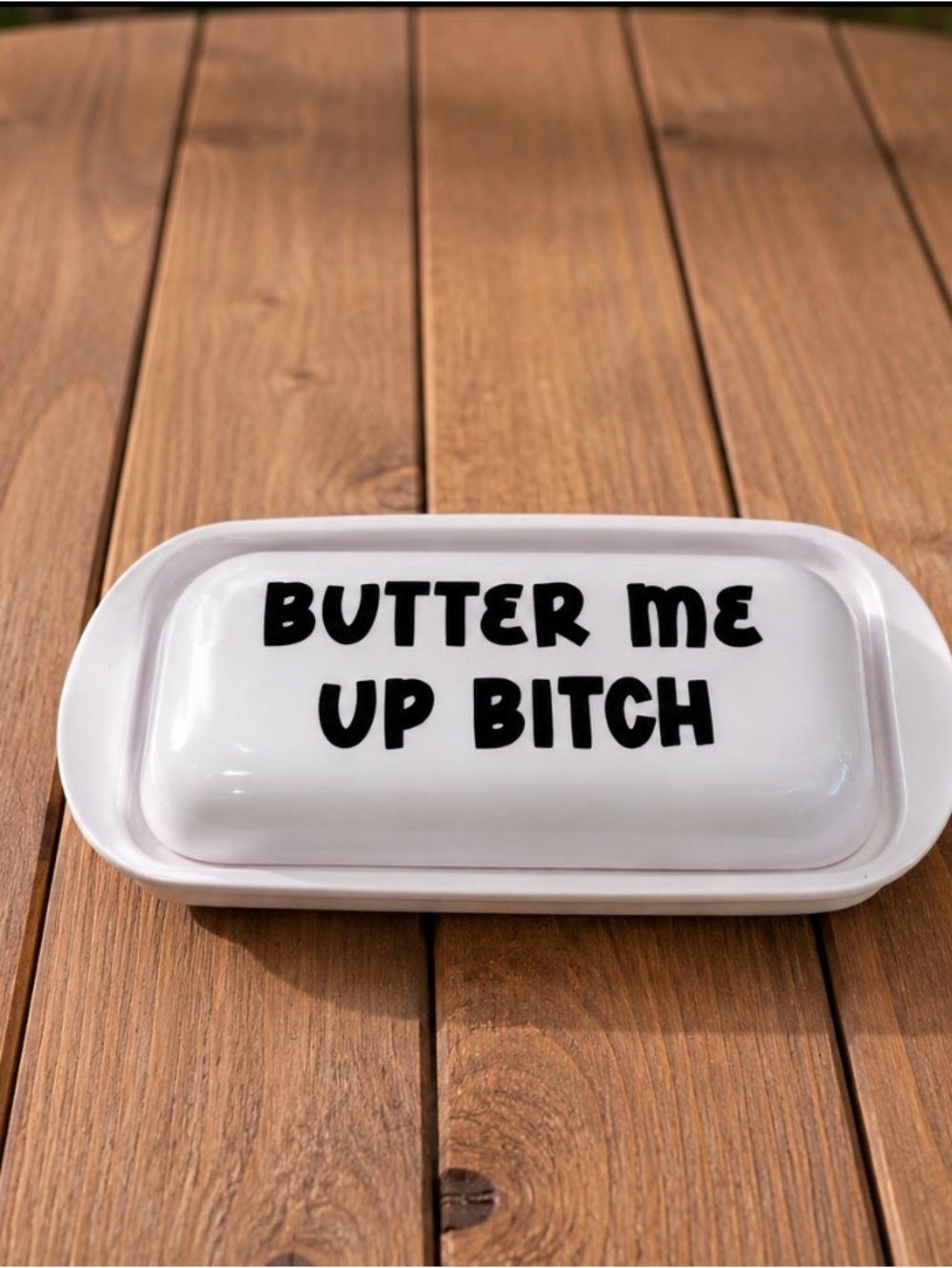 White hard plastic Butter Dish with Bold Black Text - "Butter Me Up"